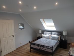 a bedroom with a bed with a skylight at Alex in Holzwickede