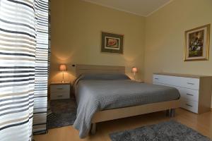 a bedroom with a bed and two night stands and two lamps at Casa Dollu in Rivarolo Canavese