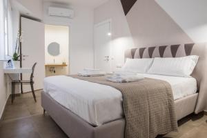 Posteľ alebo postele v izbe v ubytovaní SuitesGaribaldi