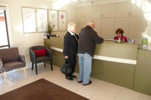 a man and a woman standing at a counter at Springs Mittagong in Mittagong