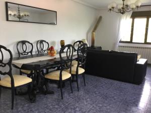 a dining room with a black table and chairs at Vis 101 in Vis