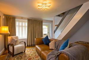 a living room with a couch and a chair at Charming Cottage Near Peak District & Chatsworth in Matlock