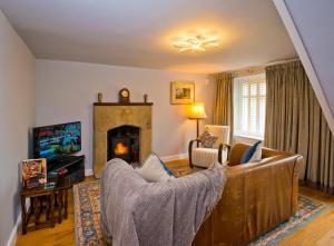 a living room with a couch and a fireplace at One Church Street in Matlock