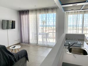 a kitchen with a sink and a counter top at Edifici Valeria in Empuriabrava