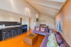 a living room with a couch and a table at Southern Ocean Villas in Port Campbell