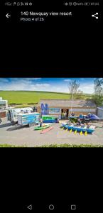 a picture of a park with kayaks and a building at Newquay Bay Resort Oakley 6 birth caravan in Newquay