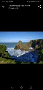 a picture of the ocean with rocks in the water at Newquay Bay Resort Oakley 6 birth caravan in Newquay