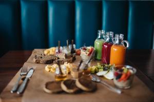 a table topped with food and bottles of juice at GiG Capsule Hostel in Ericeira