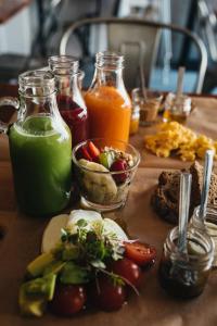 a table topped with different types of food and drinks at GiG Capsule Hostel in Ericeira
