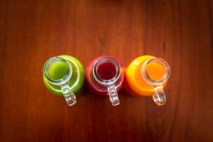 three glass jars sitting on top of a wooden table at GiG Capsule Hostel in Ericeira