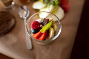 a cup filled with fruit and vegetables on a table at GiG Capsule Hostel in Ericeira