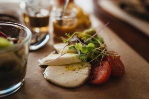 a plate of food with vegetables on a table at GiG Capsule Hostel in Ericeira