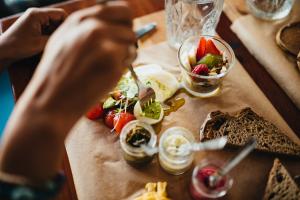 a person is eating food on a table at GiG Capsule Hostel in Ericeira