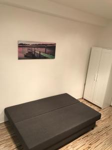 a bedroom with a bed and a painting on the wall at Студио Чайка Бургас Център in Burgas City