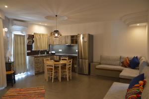 a kitchen and living room with a couch and a table at Kostas Studios in Faliraki