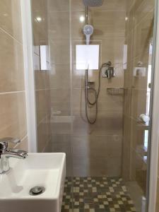 a bathroom with a shower and a sink at Ubuntu Hotel in East London +27 photos