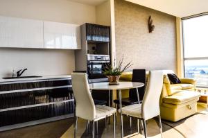 a kitchen and living room with a table and chairs at Sau Tau in Klaipėda