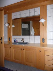 a kitchen with a sink and a mirror at Ferienwohnungen Maria Ginther in Pinswang