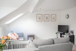 a living room with a couch and a tv at Arch View in Whitby