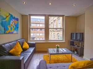 a living room with a couch and a tv at Spacesavers at Figtree Lane in Sheffield