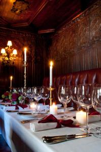 a long table with wine glasses and candles on it at The Witchery by the Castle in Edinburgh