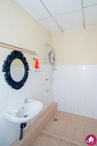 a white bathroom with a sink and a mirror at Dream Borneo Budget Homestay Kota Kinabalu in Penampang