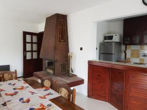 a kitchen with a table and a stove in it at Slantse in Sozopol
