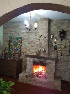 a stone wall with a fireplace in a room at Casa da Kau in Ouro Preto