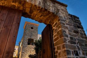 a brick wall with a clock tower in the background at Villa Venus Resort & SPA in Atena Lucana