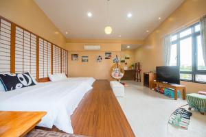 Llit o llits en una habitació de Quan World My Home B&B