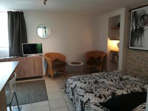 a small room with a bed and a television at Chez Karine et Julien in Cahors
