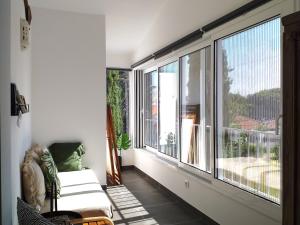 a living room with a large window and a couch at Pedras D'el Rei Waterfront Loft in Tavira