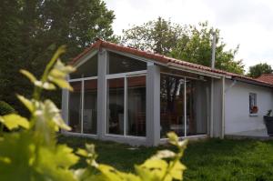 a house with large sliding glass doors at Les Agapanthes du frontonnais in Bouloc