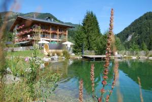 a large building in the middle of a lake at Herbst Alm in Unken