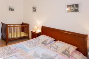 a bedroom with a crib and a bed with a map at Angels Inn in Coutevroult