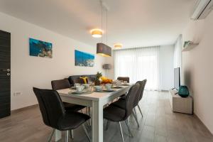 a dining room with a table and chairs at Luxury Villa Rivabel in Malinska
