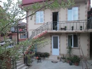 a house with a balcony and a patio at Dream Land Batumi in Batumi