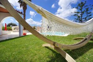 a hammock on the grass in a yard at Casa Bella Chania in Chorafakia