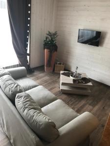 a living room with a couch and a table at Ferienwohnung Zum alten Rathaus in Schleiden