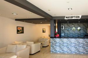 a waiting room with couches and a reception counter at Konfor Suite Otel in Oludeniz +63 photos