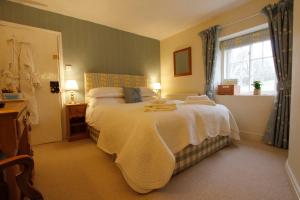 a bedroom with a large bed and a window at Firs Farm B&B in Masham