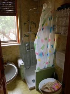 a bathroom with a shower and a tub and a sink at Villa Aurora in Ognina