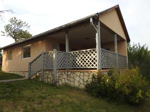 a house with a large deck on the side of it at Akali Apartman in Balatonakali