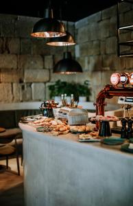a buffet line with food on top of it at Exmo Hotel by Olivia in Porto