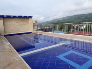 a swimming pool on top of a building at Hotel Bellavista Premium in Villeta