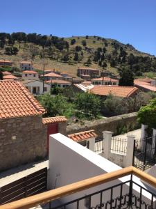 a view of a city from the balcony of a building at Loukia in Kondiás +3 photos