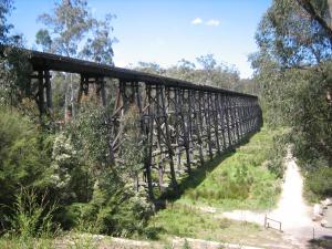 a bridge over a dirt road next to a trail at Orbost Country Road Motor Inn in Orbost