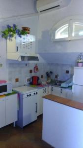 a small kitchen with white cabinets and a sink at Giglio di mare Marzamemi in Marzamemi