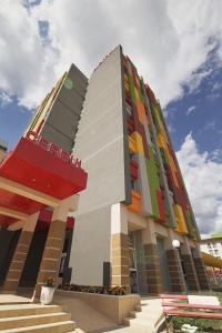 a building with a multicolored facade with stairs in front at Complex Balnear Cerbul in Covasna