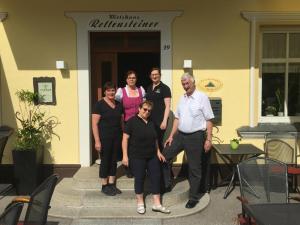 a group of people standing outside of a building at Rettensteinerhof Wirtshaus in Hollenstein an der Ybbs